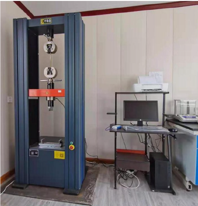 Quality control laboratory with technician performing material tests