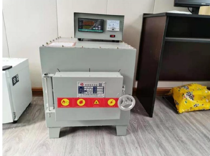 Quality control laboratory with technician performing material tests