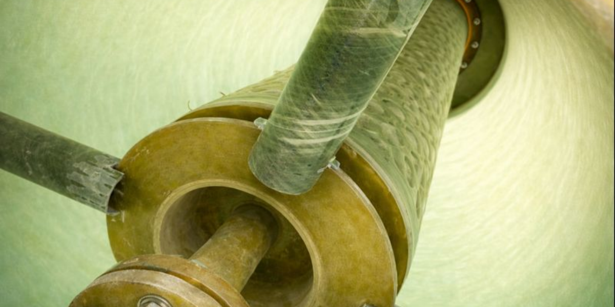 Multiple cylindrical FRP fiber bed mist eliminator units with corrosion-resistant housing